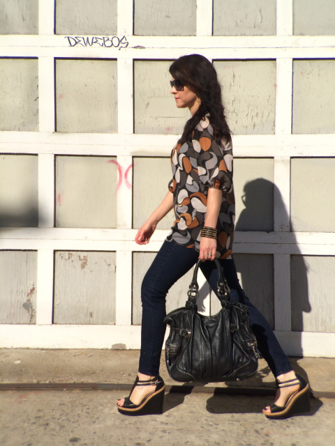 Fashionable Brunette Walking By Downtown Los Angeles Industrial Garage Door In Black Wedges