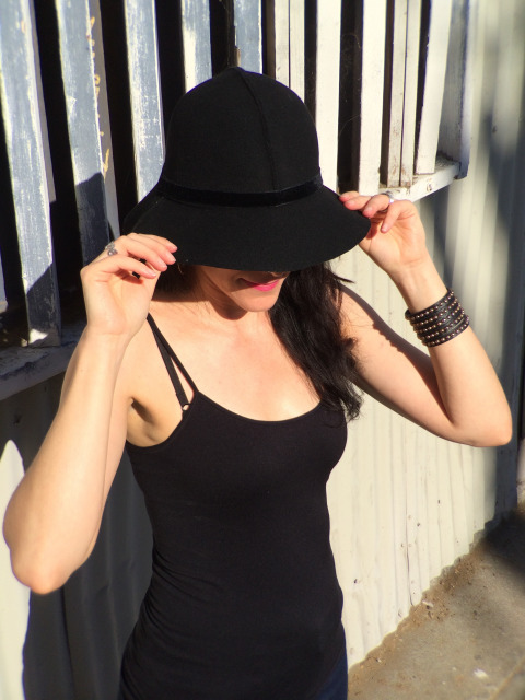 Brunette Modeling Spaghetti Strap Black Top And Black Hat